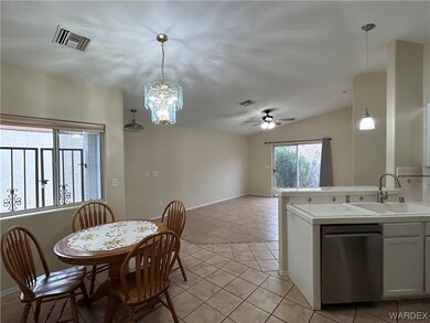Tiled dining area with sink and ceiling fan with n