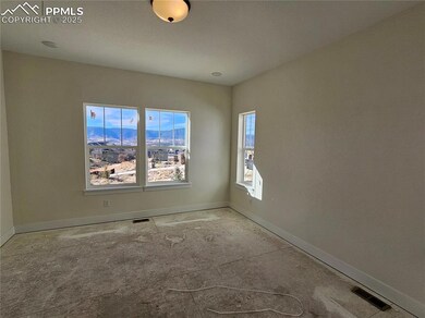 Unfurnished room featuring a mountain view and baseboards