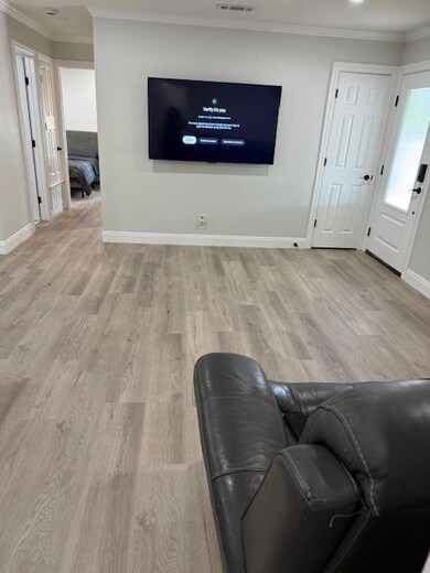 Living room featuring ornamental molding and wood