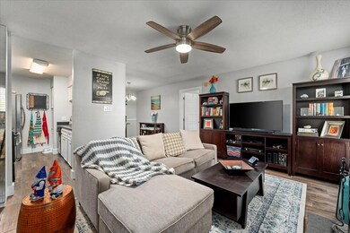 Living area with wood finished floors, a ceiling 