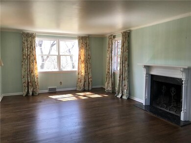 Gracious living room with hardwood floors, log bur