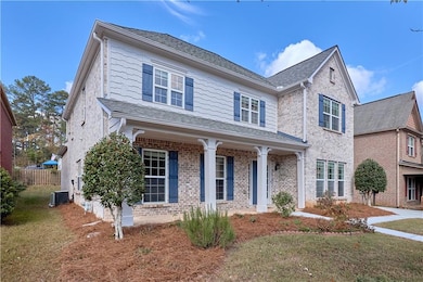 View of front of home featuring a front yard and central AC