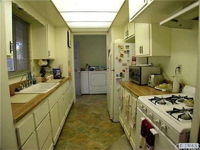 Side kitchen and laundry room leads out to breezew