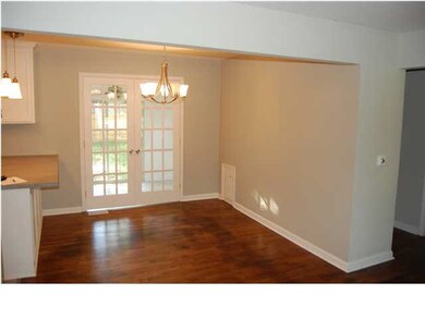 DINING AREA WITH WOOD FLOOR AND FRENCH DOORS TO SU