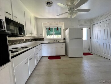 Kitchen featuring a sink, a ceiling fan, appliance