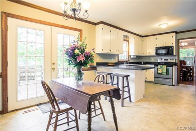 Kitchen french doors open to rear deck. Breakfast bar option for entertaining or quick meals!