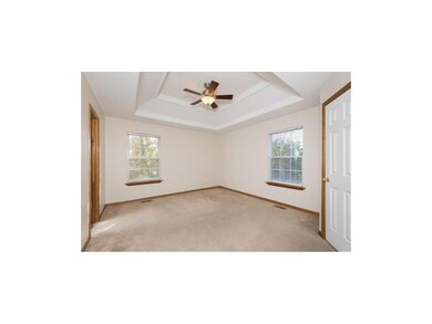 Master bedroom with coffered ceiling and walk-in c