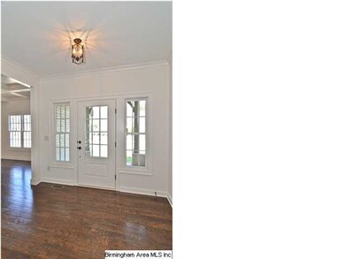 Entry way with gleaming hard wood floors.
