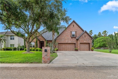 Traditional home featuring concrete driveway, a garage, a front lawn, and brick siding