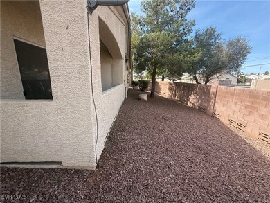 View of side of home with fence and stucco siding