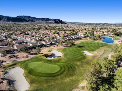 View of property location featuring a local golf course, nearby suburban area, and a water and mountain view