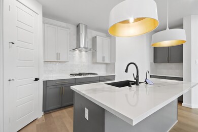 Beautiful fresh and modern kitchen with, white porcelain, countertops, and white upper cabinets and grey lower cabinets.