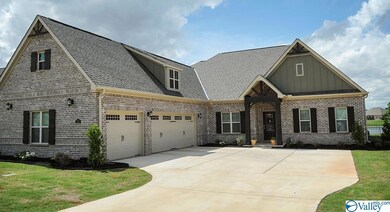 Wonderful details on the exterior of this home include eave lighting and lovely landscaping.
