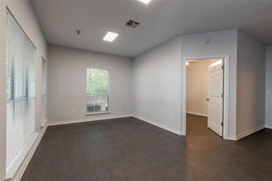 Empty room featuring a smoke detector and dark wo