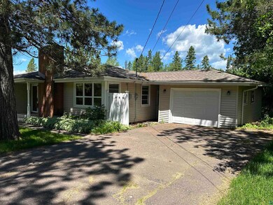 East side of home with view of the garage.