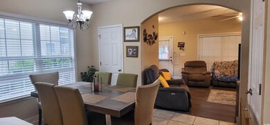 Dining space featuring ceiling fan with notable ch