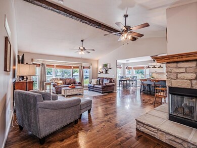 Two-Sided Corner Fireplace greets you at the entry