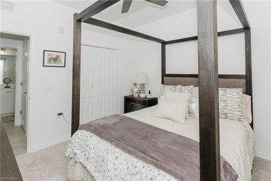 Carpeted bedroom with a closet and ceiling fan