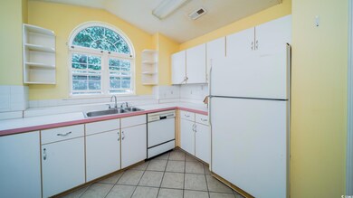 Kitchen with white appliances, open shelves, a sink, vaulted ceiling, and white cabinetry