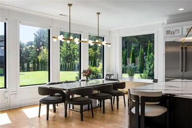 Dining space with light wood-type flooring and a chandelier