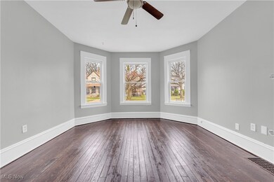 Spare room with a ceiling fan, baseboards, a healthy amount of sunlight, and visible vents