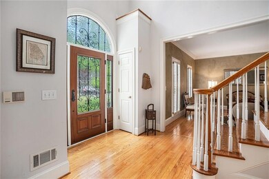 Foyer entrance featuring baseboards, light wood fi