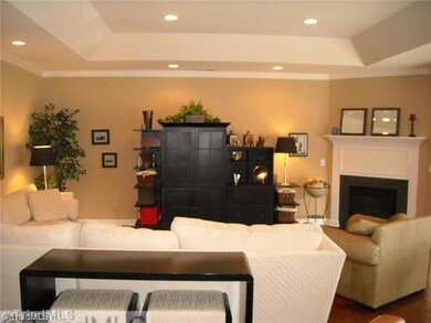 Living Room. Tray ceiling with recessed lighting enhances the already spacious feel of this townhome. Open plan makes for smooth traffic flow.Gorgeous hardwoods throughout kitchen, living room and sunroom...