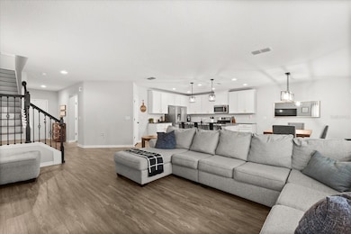 Living room, kitchen view and stairs
