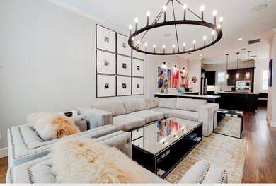 Living area featuring an inviting chandelier, orna