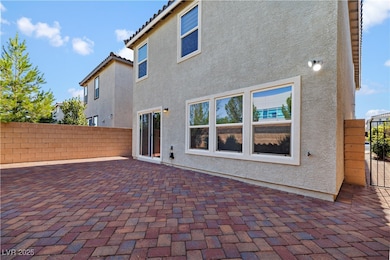 Rear view of property with a patio area and stucco