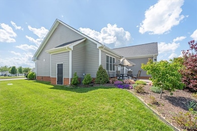 View of side of home featuring a yard