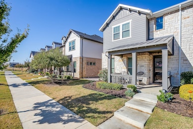 View of front facade featuring a standing seam roof, and covered porch