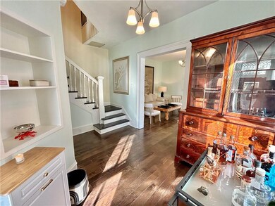 Foyer leads to staircase and living room