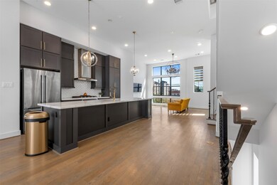 Bright and open kitchen seamlessly flowing into the living room, perfect for entertaining or everyday living. Modern finishes and abundant natural light create a warm, inviting space.