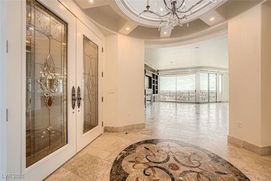 Hallway with stone tile floors, baseboards, french