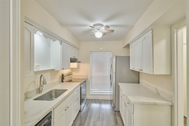 Bright and modern kitchen with white cabinetry, st