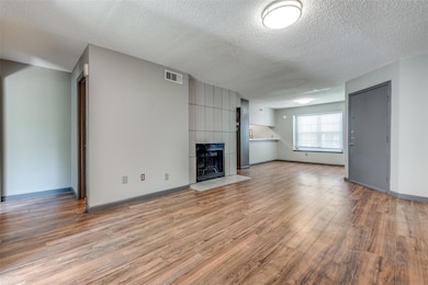 Living room featuring a modern tile surround firep