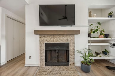 Room details featuring a tile fireplace, built in 