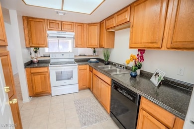 Kitchen with white electric range, under cabinet r