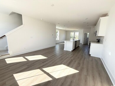 Unfurnished living room featuring dark wood finished floors, stairs, and recessed lighting