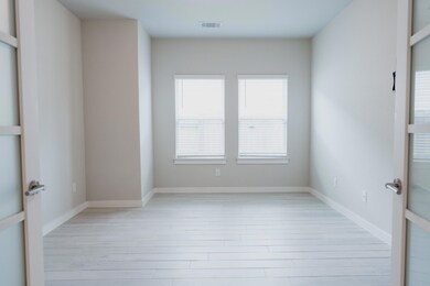 Spare room featuring light wood-style floors, bas