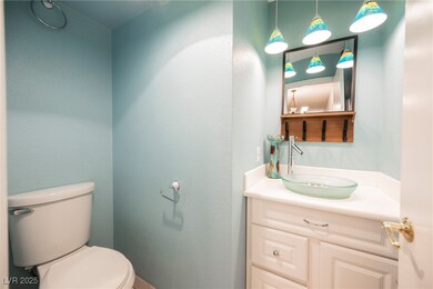 Half bathroom with toilet and vanity