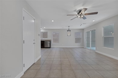 Unfurnished living room with a ceiling fan, light