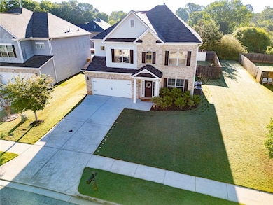 Traditional home featuring driveway, brick siding,
