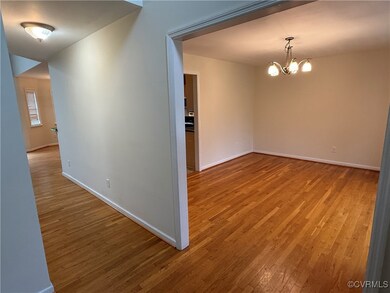 Unfurnished room with wood finished floors and a c