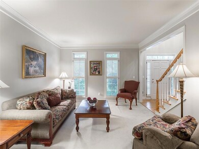 Living area with ornamental molding, carpet floors