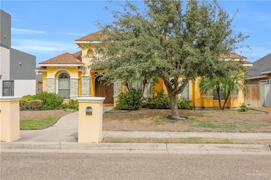 Mediterranean / spanish-style home with stone siding, stucco siding, and roof with shingles