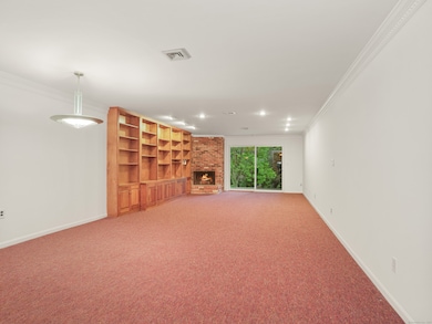 Living room with built-ins and slider to patio.