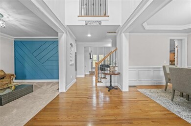 Spare room featuring crown molding, carpet, and a chandelier