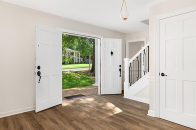 Entrance foyer featuring crown molding and dark ha